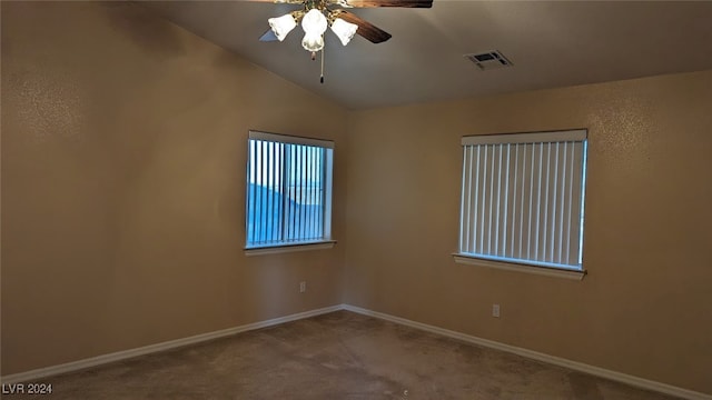 carpeted spare room with lofted ceiling and ceiling fan