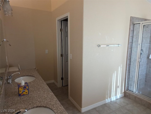 bathroom featuring vanity, tile patterned floors, and walk in shower