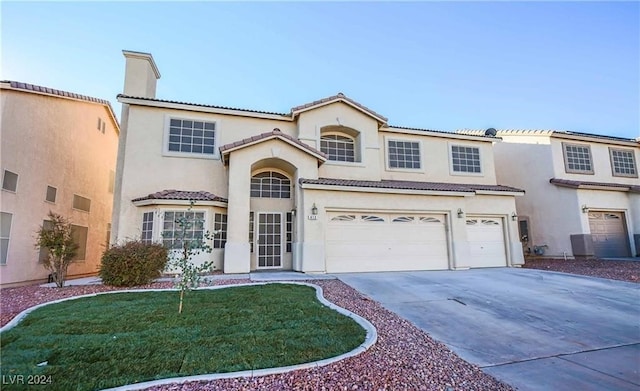 view of front of home featuring a front yard and a garage