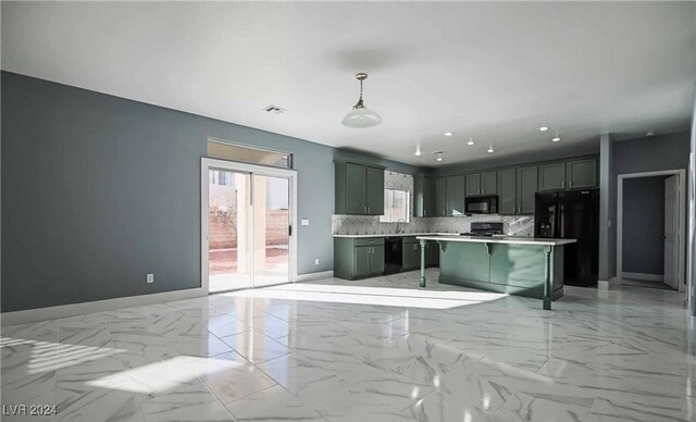 kitchen with hanging light fixtures, black appliances, a center island, decorative backsplash, and a breakfast bar