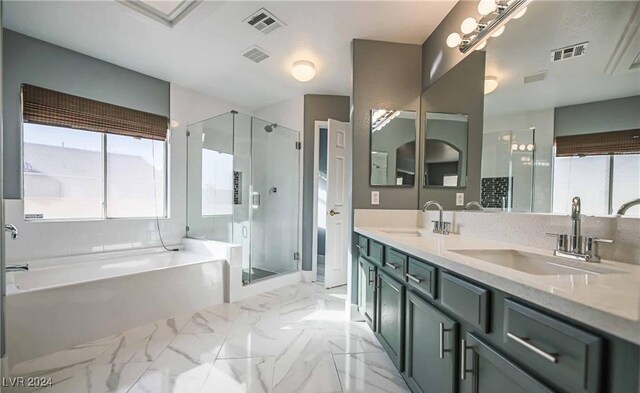 bathroom featuring vanity and shower with separate bathtub