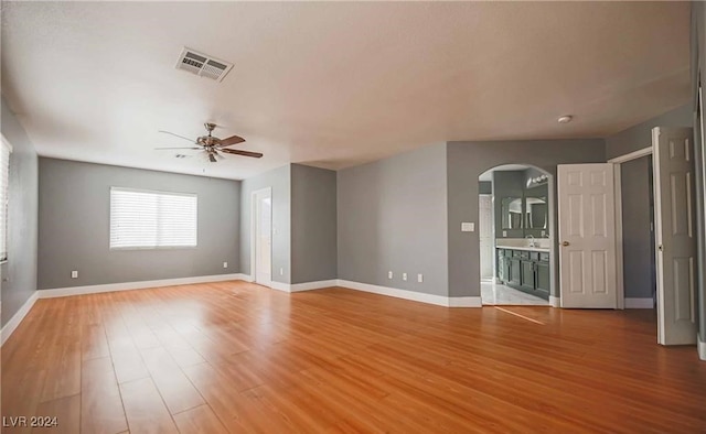 spare room featuring ceiling fan, sink, and hardwood / wood-style floors