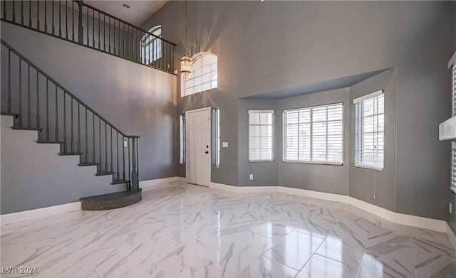 foyer entrance with a towering ceiling and an inviting chandelier