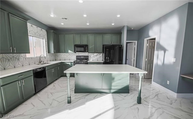 kitchen with black appliances, a kitchen island, green cabinetry, and a breakfast bar