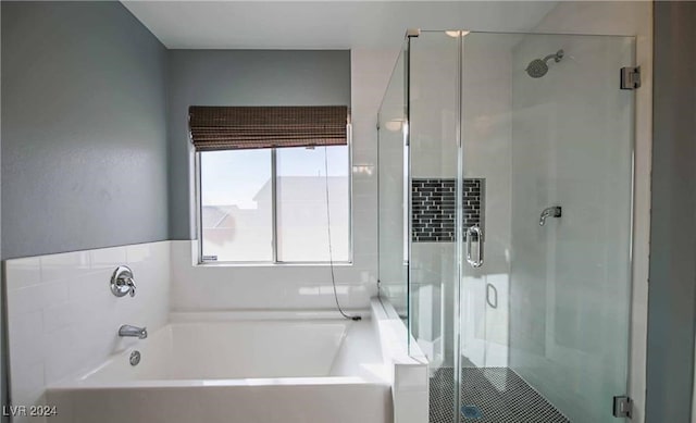 bathroom with shower with separate bathtub