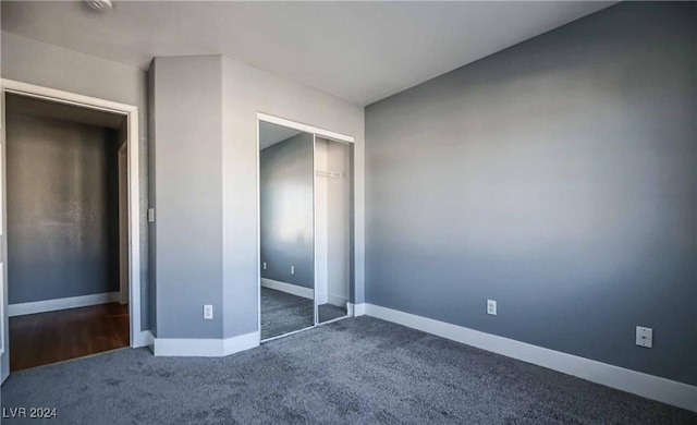 unfurnished bedroom featuring carpet and a closet