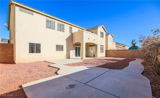 rear view of property featuring a patio