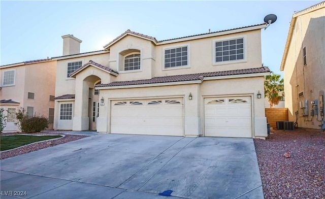 mediterranean / spanish-style house with a garage