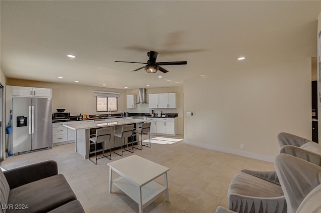 living room with ceiling fan and sink