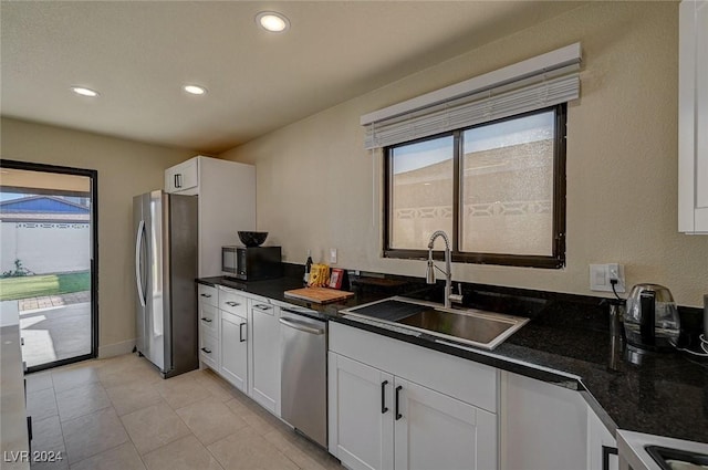 4729 Bennett Dr, Las Vegas, NV 89121 - kitchen featuring a sink, dark countertops, freestanding refrigerator, recessed lighting, and white cabinetry