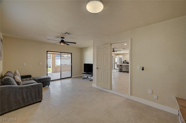 4729 Bennett Dr, Las Vegas, NV 89121 - living area with visible vents, ceiling fan, baseboards, and a textured ceiling
