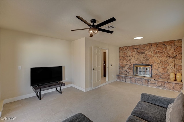 living room with ceiling fan and a fireplace