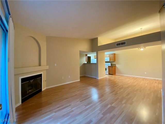 unfurnished living room with light wood-type flooring