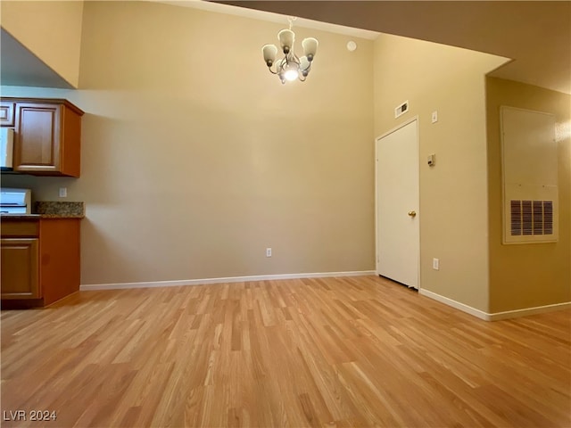 interior space with a notable chandelier and light hardwood / wood-style floors