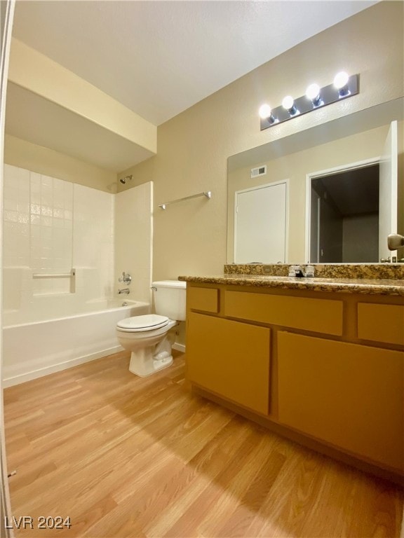 full bathroom featuring toilet, hardwood / wood-style flooring, shower / bathing tub combination, and vanity