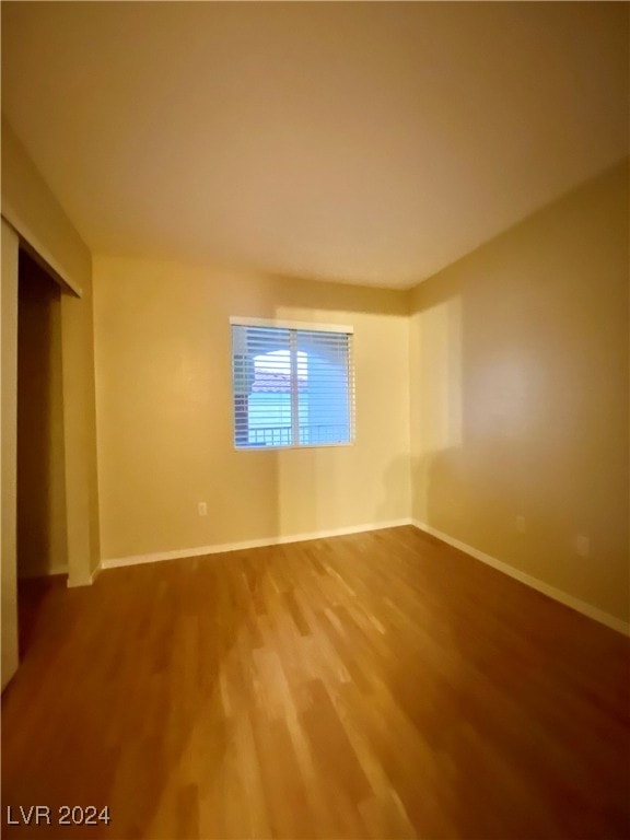 empty room with hardwood / wood-style flooring