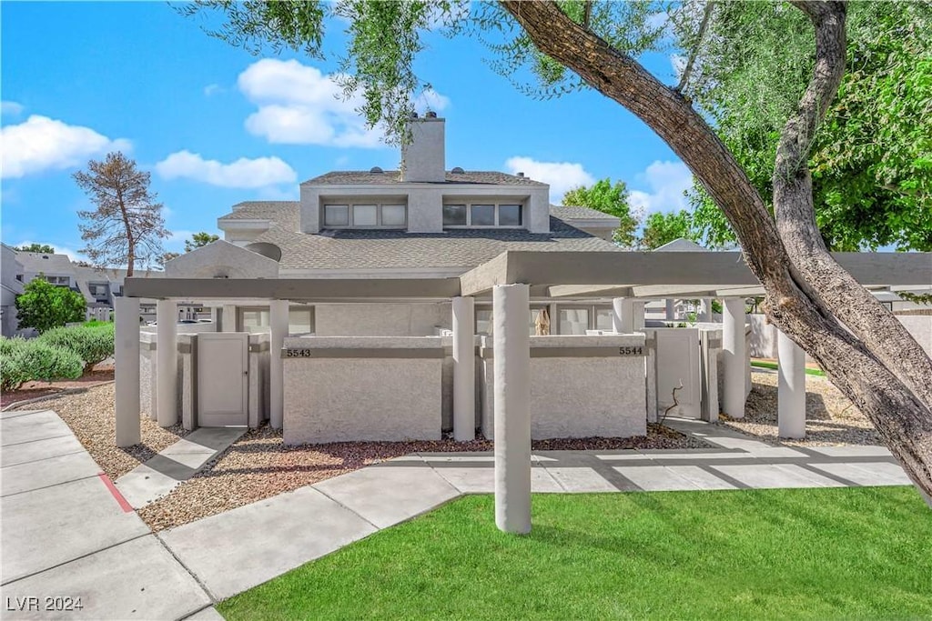 view of front of property with a gate, a chimney, a fenced front yard, and stucco siding