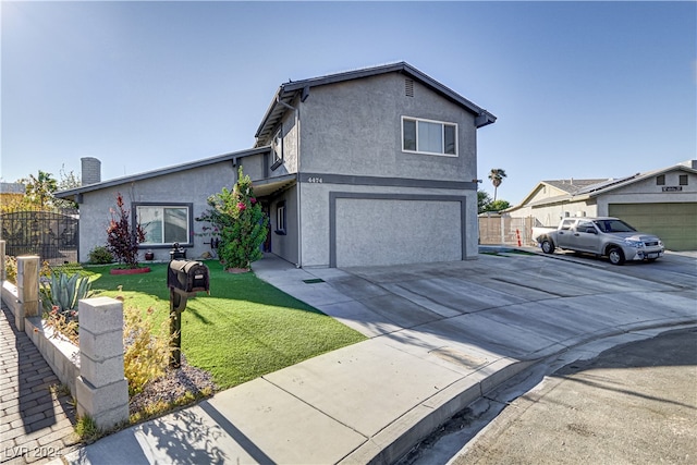 view of front of house featuring a garage and a front lawn