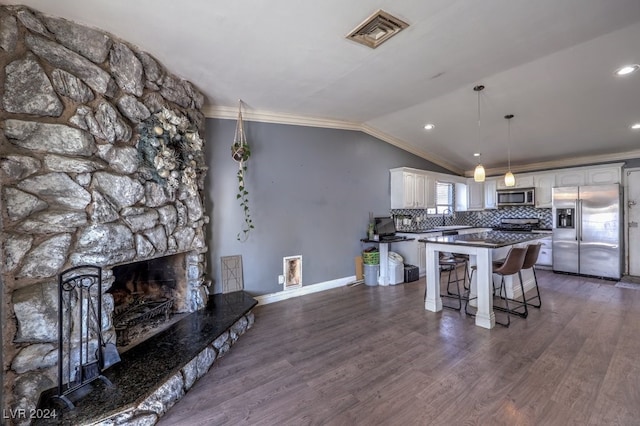 kitchen with sink, white cabinetry, vaulted ceiling, stainless steel appliances, and dark hardwood / wood-style flooring