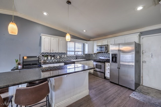 kitchen featuring sink, white cabinets, lofted ceiling, appliances with stainless steel finishes, and dark hardwood / wood-style flooring