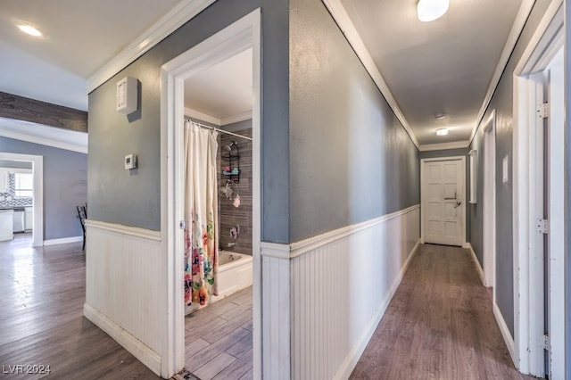 hallway with crown molding and hardwood / wood-style floors