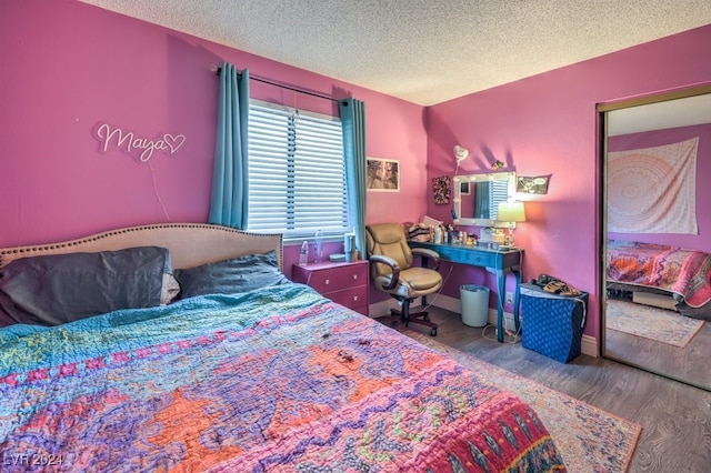 bedroom featuring a textured ceiling and hardwood / wood-style floors