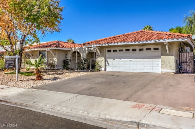 mediterranean / spanish home featuring a garage