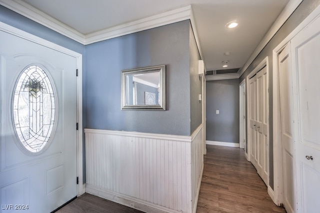 foyer entrance featuring crown molding and dark hardwood / wood-style floors