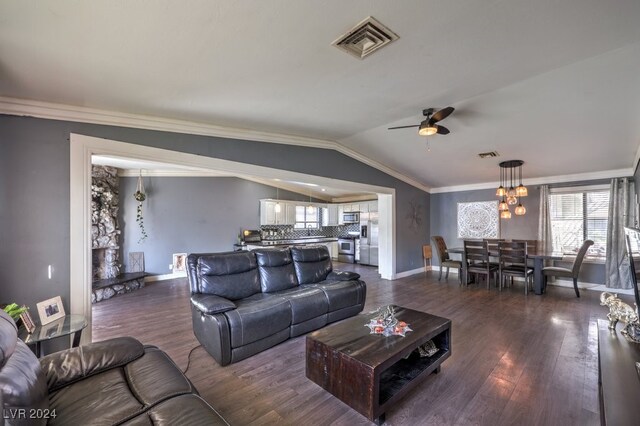 living room featuring crown molding, lofted ceiling, dark hardwood / wood-style flooring, and ceiling fan