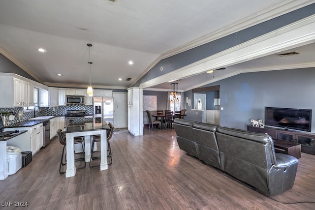 living room with crown molding, lofted ceiling, dark hardwood / wood-style flooring, and sink