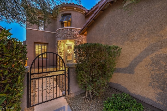 view of gate with a fenced front yard