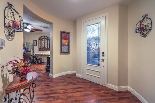 entryway with ceiling fan and dark wood-type flooring