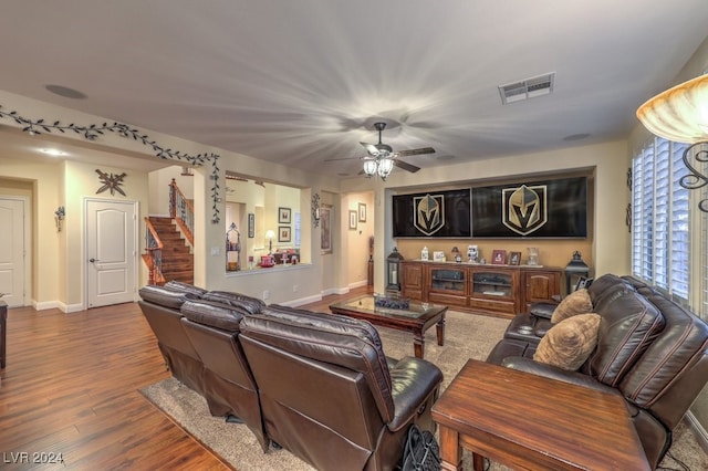 living room featuring ceiling fan and hardwood / wood-style floors