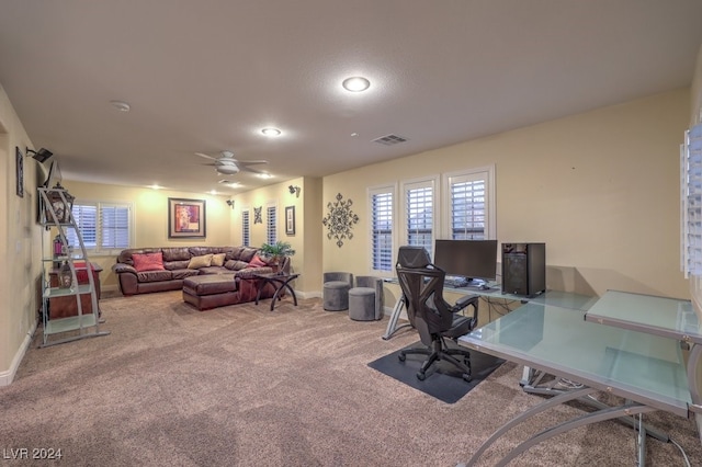 home office featuring baseboards, visible vents, a ceiling fan, and carpet