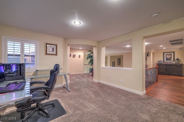 office area with carpet floors and a textured ceiling