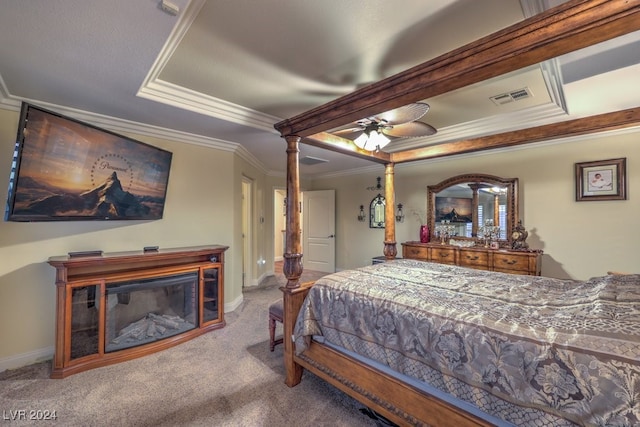 bedroom featuring baseboards, visible vents, carpet floors, ornamental molding, and a glass covered fireplace