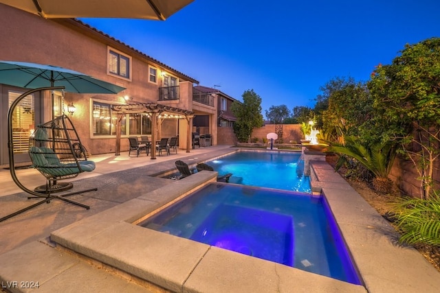 view of swimming pool with an in ground hot tub, a patio area, and a pergola