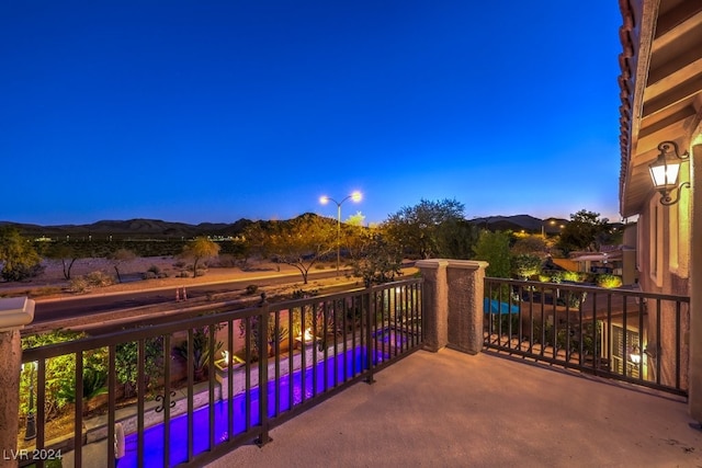 balcony at dusk with a mountain view