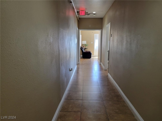 hall with tile patterned flooring