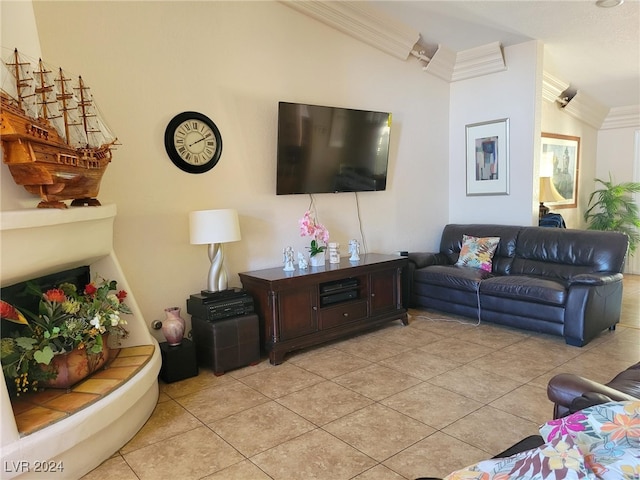 living room featuring ornamental molding, vaulted ceiling, and light tile patterned floors