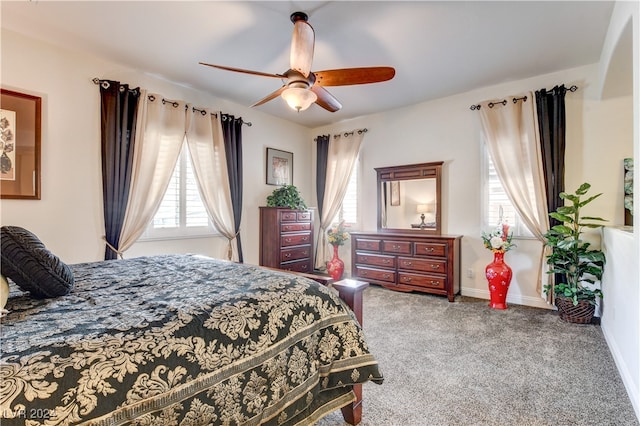 bedroom featuring ceiling fan and carpet