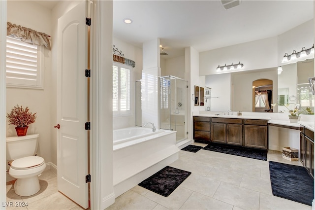 full bathroom featuring vanity, toilet, plus walk in shower, and tile patterned floors