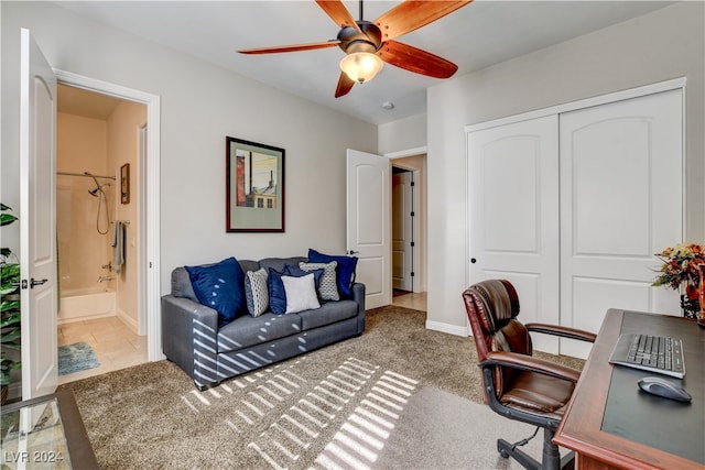 office space featuring light carpet and ceiling fan