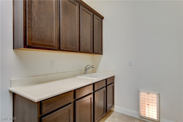 laundry room featuring light tile patterned floors and sink