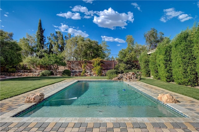 view of pool featuring a lawn