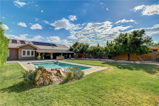 view of pool with a lawn and a patio