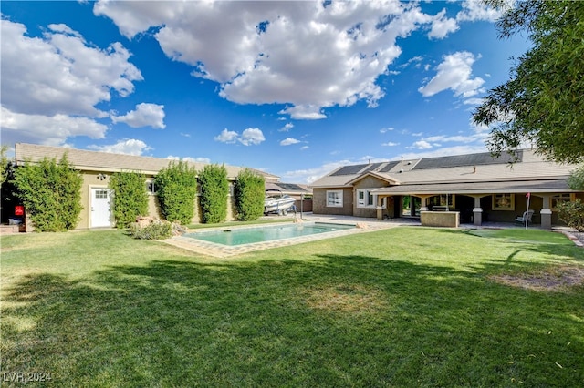 view of swimming pool featuring a lawn and a patio area