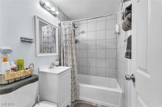 bathroom with a textured wall, shower / tub combo, a sink, and toilet