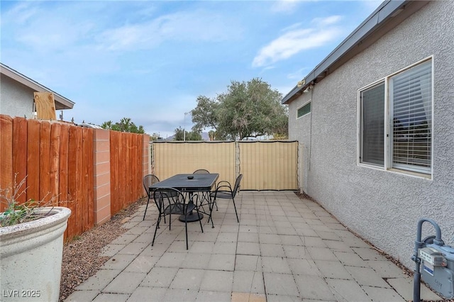 view of patio featuring outdoor dining space and a fenced backyard