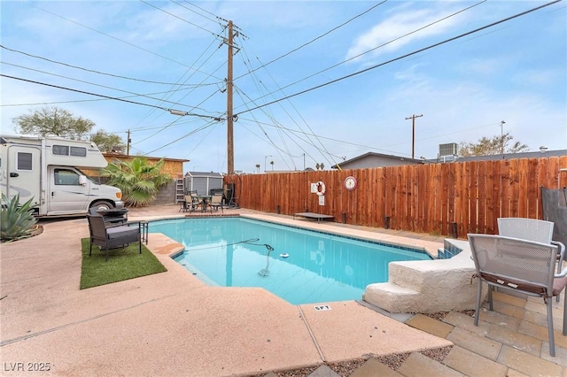 view of pool featuring a fenced in pool, a patio area, and fence